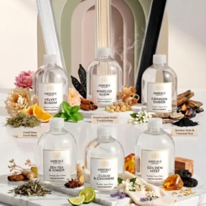 Amberly reed diffuser fragrance oil refill collection showcasing six signature scents in glass bottles with reed sticks on a clean surface.